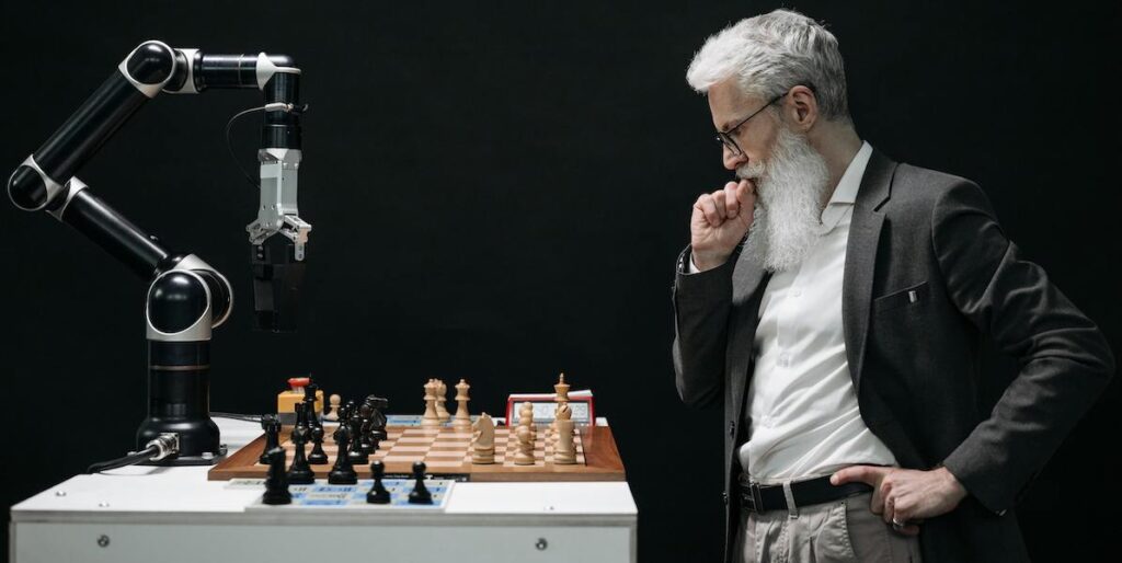 man playing chess vs robot